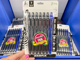 Hand holding 7-count package of Zebra Ballpoint Pens at Walmart