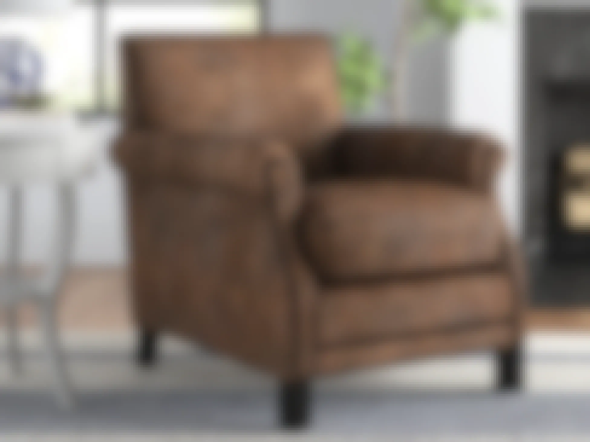 A Brown Leather Look-alike Club Chair from Wayfair staged in a living room.