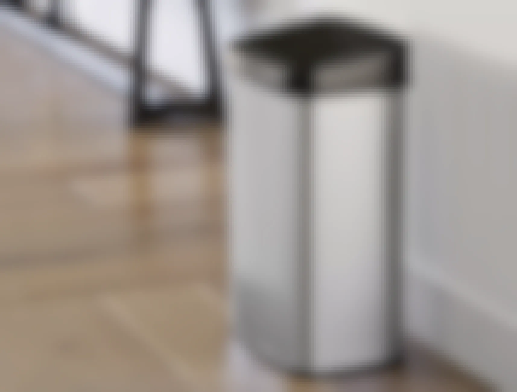 A Stainless Steel 13.2 Gallon Motion Sensor Trash Can from Wayfair staged in a kitchen.