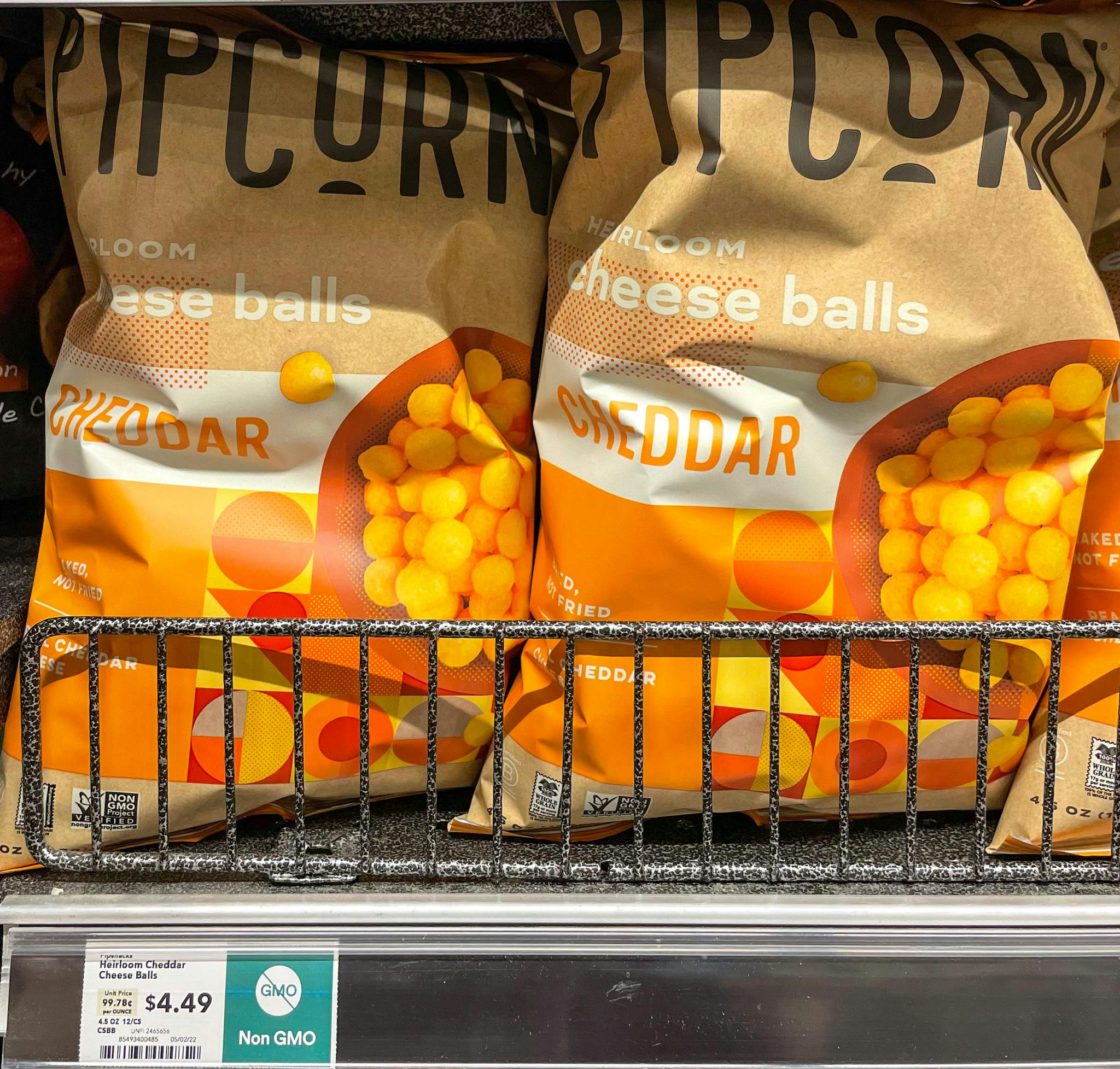pipcorn cheese balls on a shelf at whole foods
