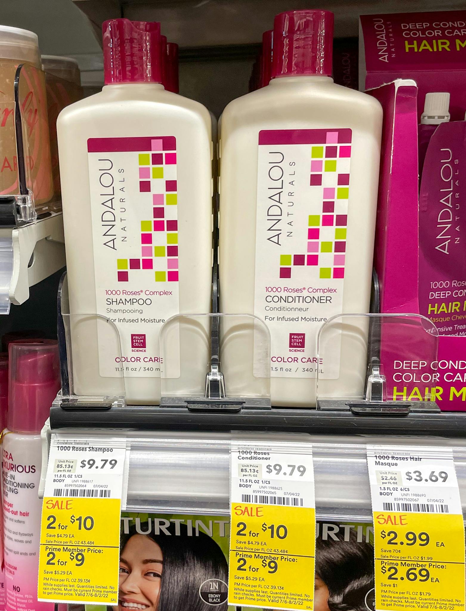 andalou shampoo and conditioner on a shelf at whole foods with sales tag 