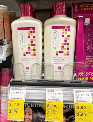 andalou shampoo and conditioner on a shelf at whole foods with sales tag