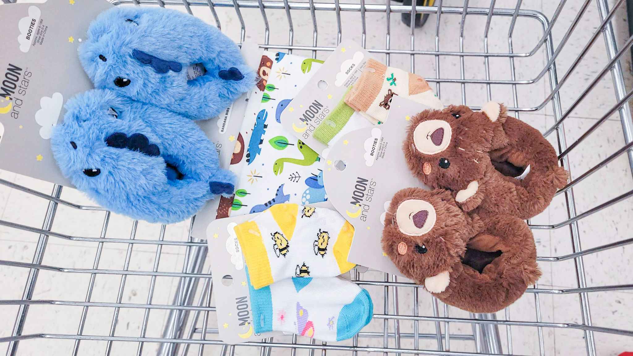 baby booties, baby socks, and baby scarves in shopping basket