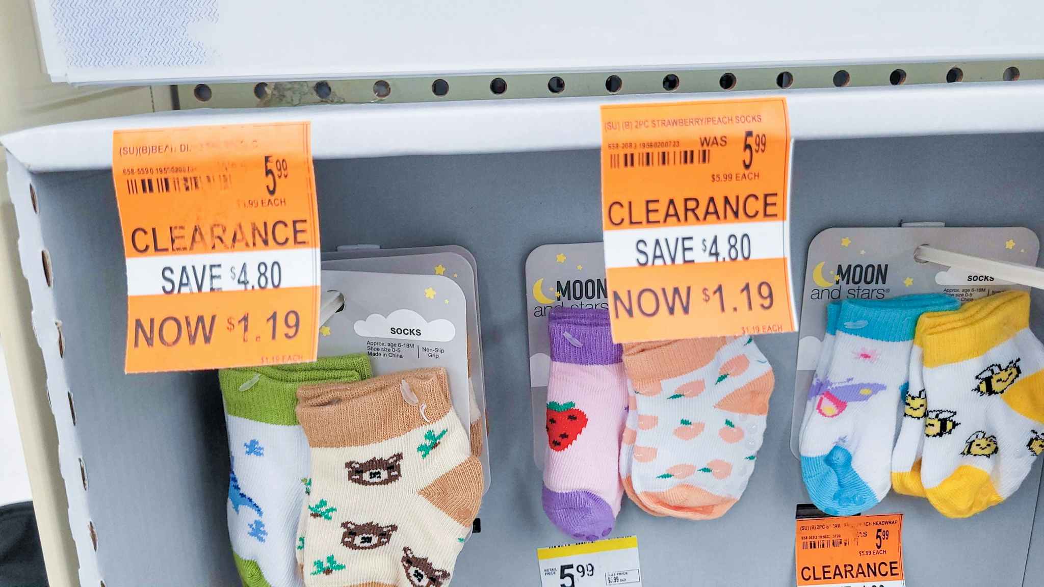 orange tags showing Walgreens clearance on baby sock