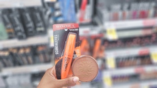 hand holding rimmel mascara and bronzer
