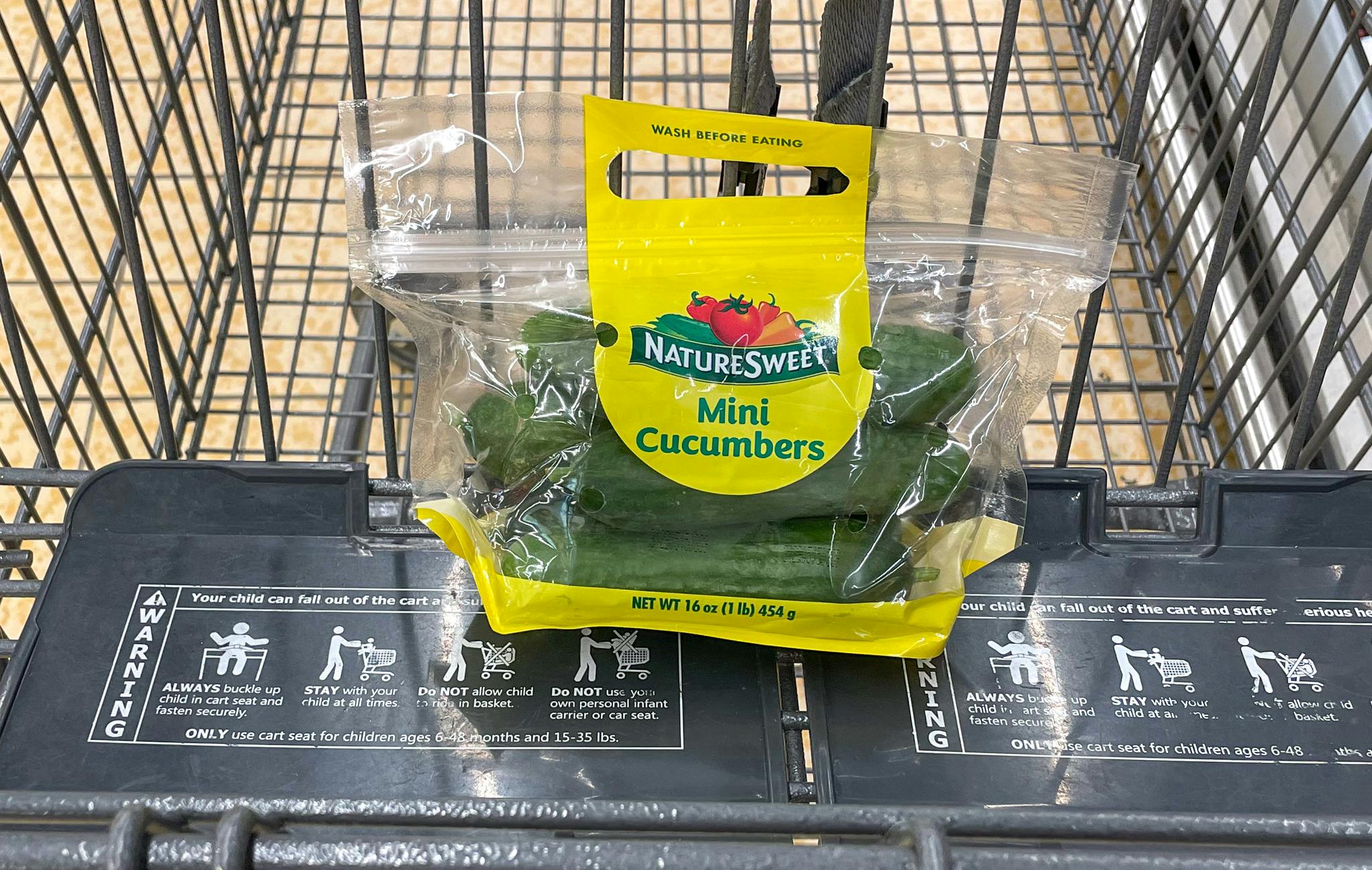 packaged mini cucumbers in a cart at aldi