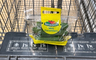 packaged mini cucumbers in a cart at aldi