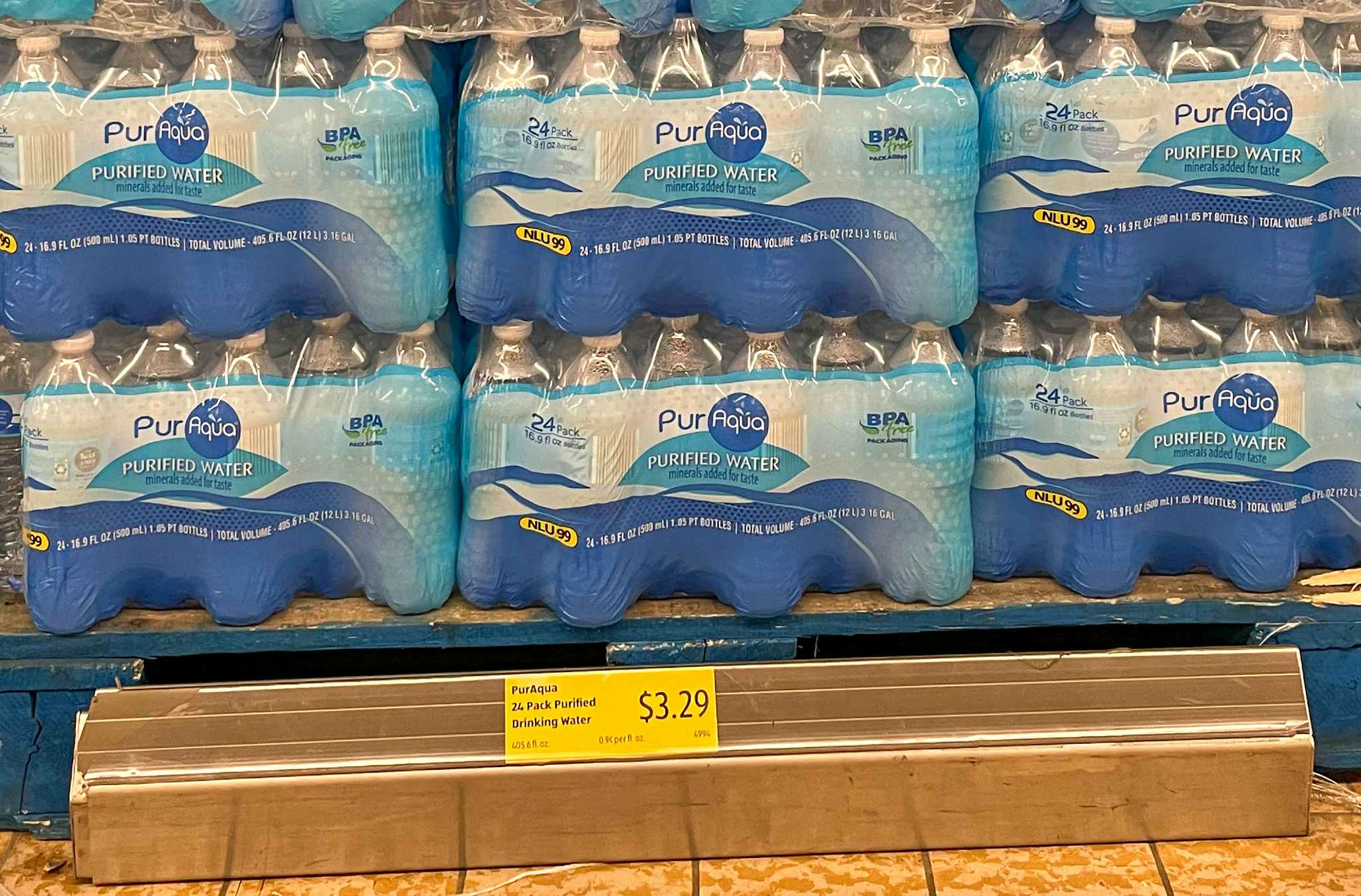 cases of drinking water on the sales floor at aldi with sales sign