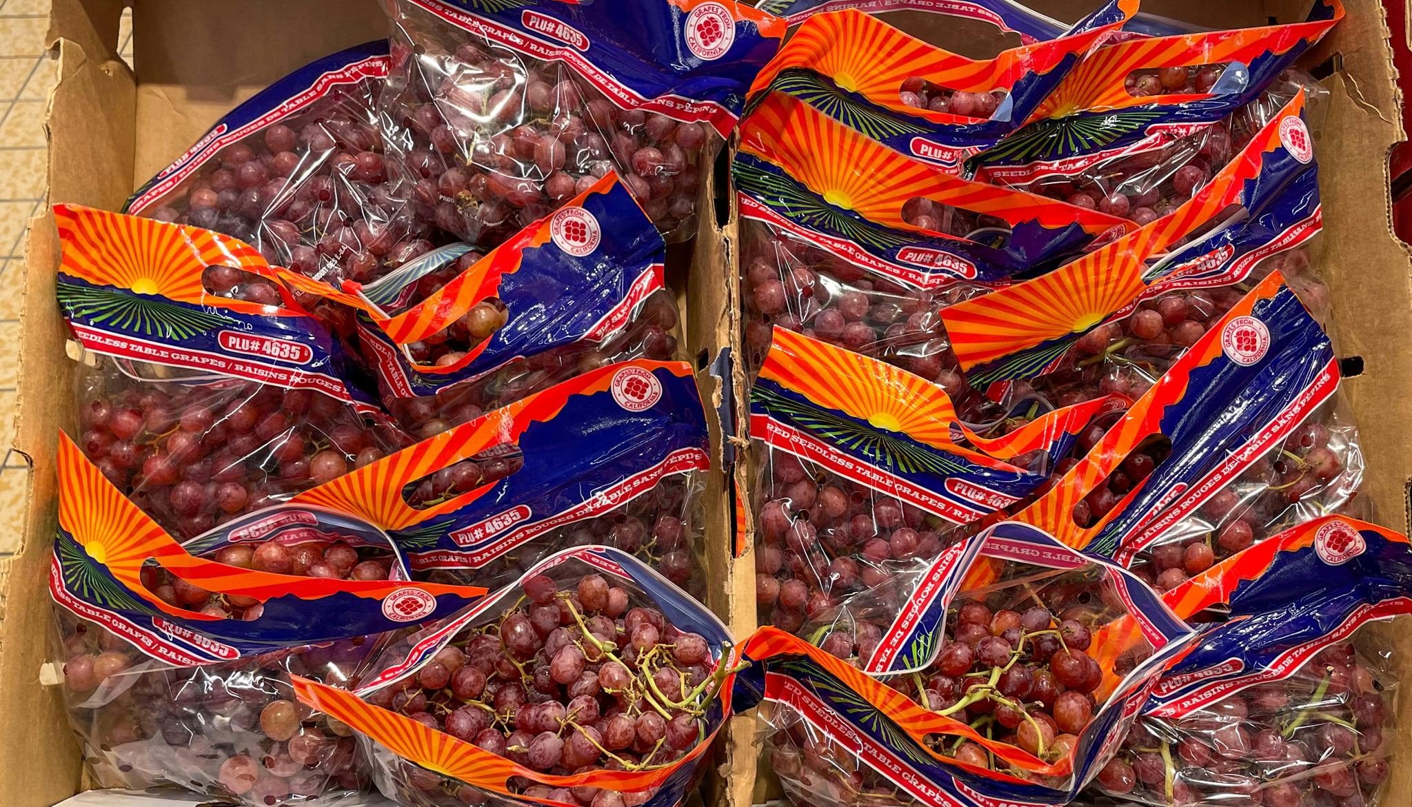 red grapes in bags in a box at aldi