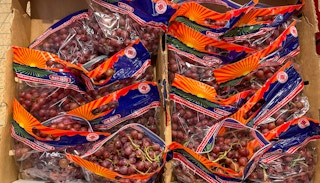 red grapes in bags in a box at aldi