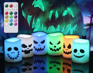 Colorful flameless candles on a black background with green lights