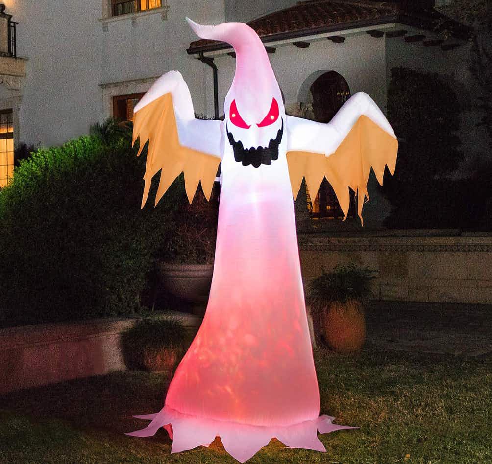Red and white inflatable ghost in a yard