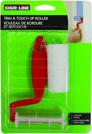 A paint roller kit in a green package.
