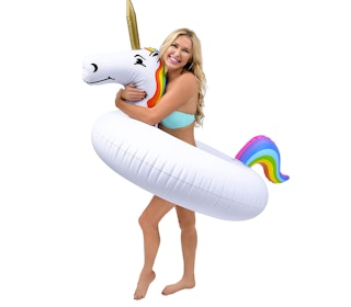 A woman holding a unicorn pool float