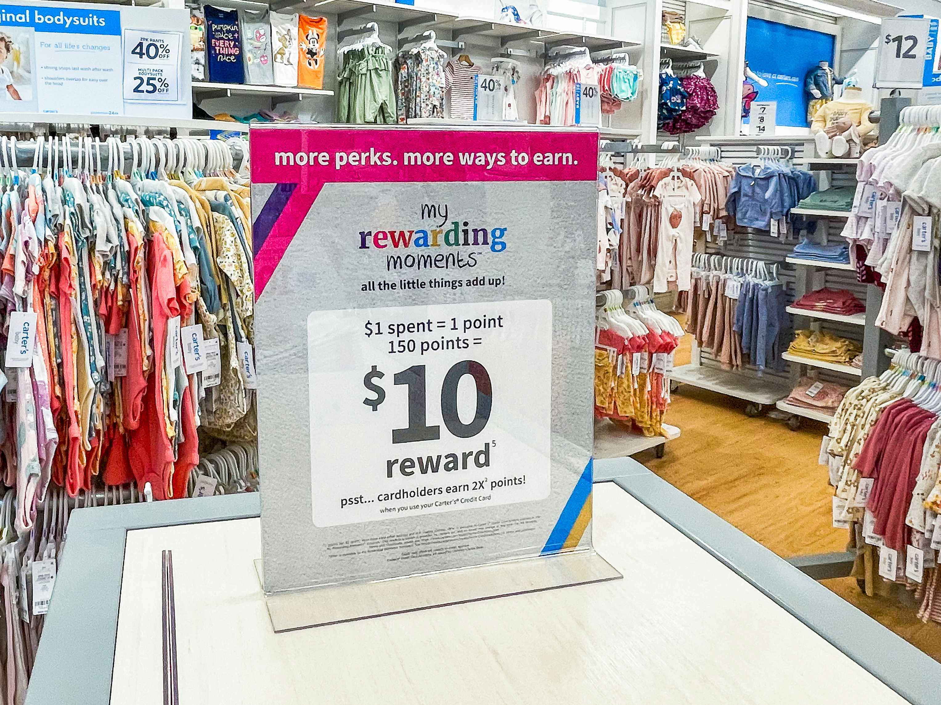 A sign for the Carter's My Rewarding Moments program advertising an offer of $10 for points earned through purchases.