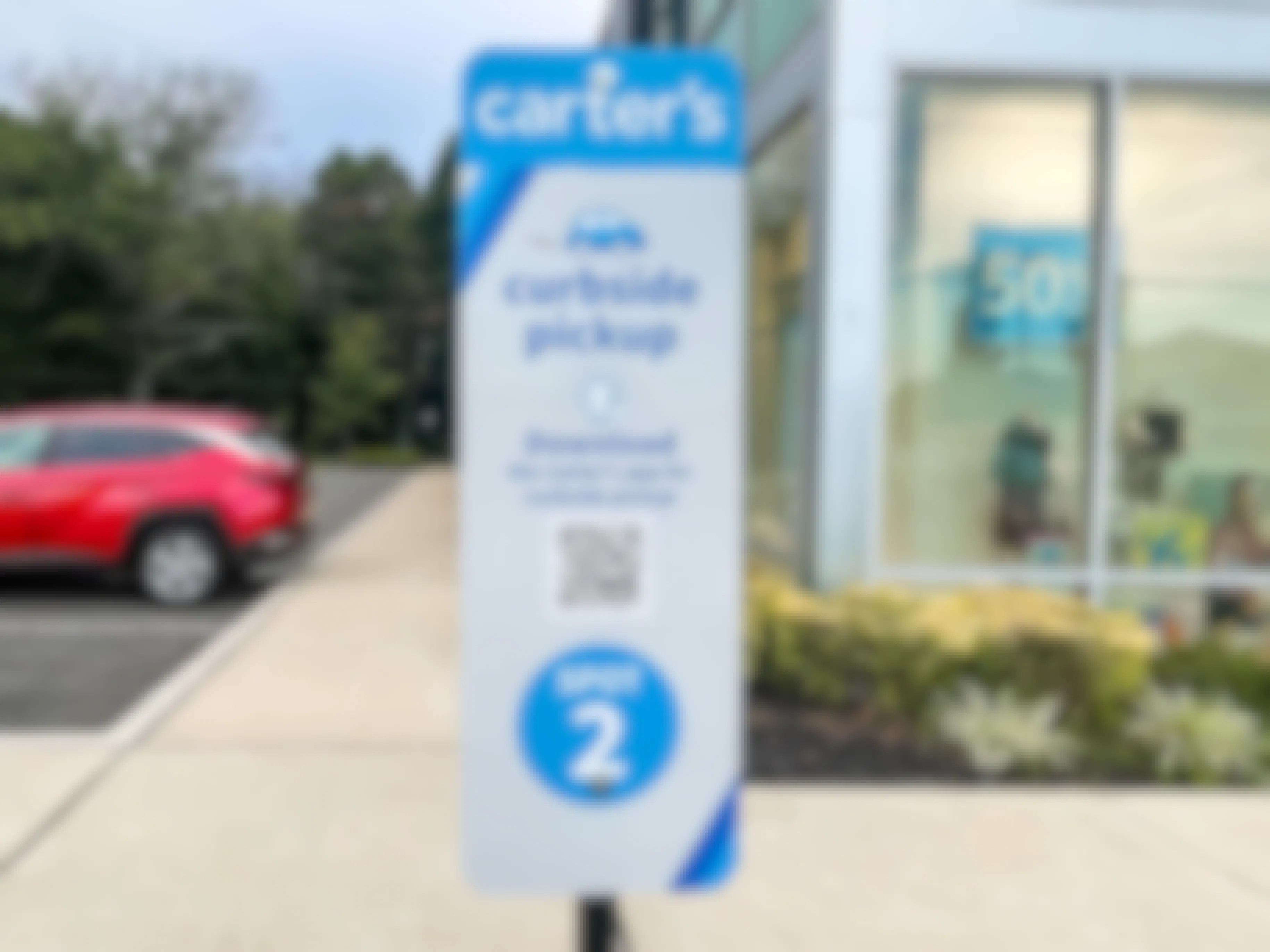 A Carter's online order curbside pickup sign outside of the store.
