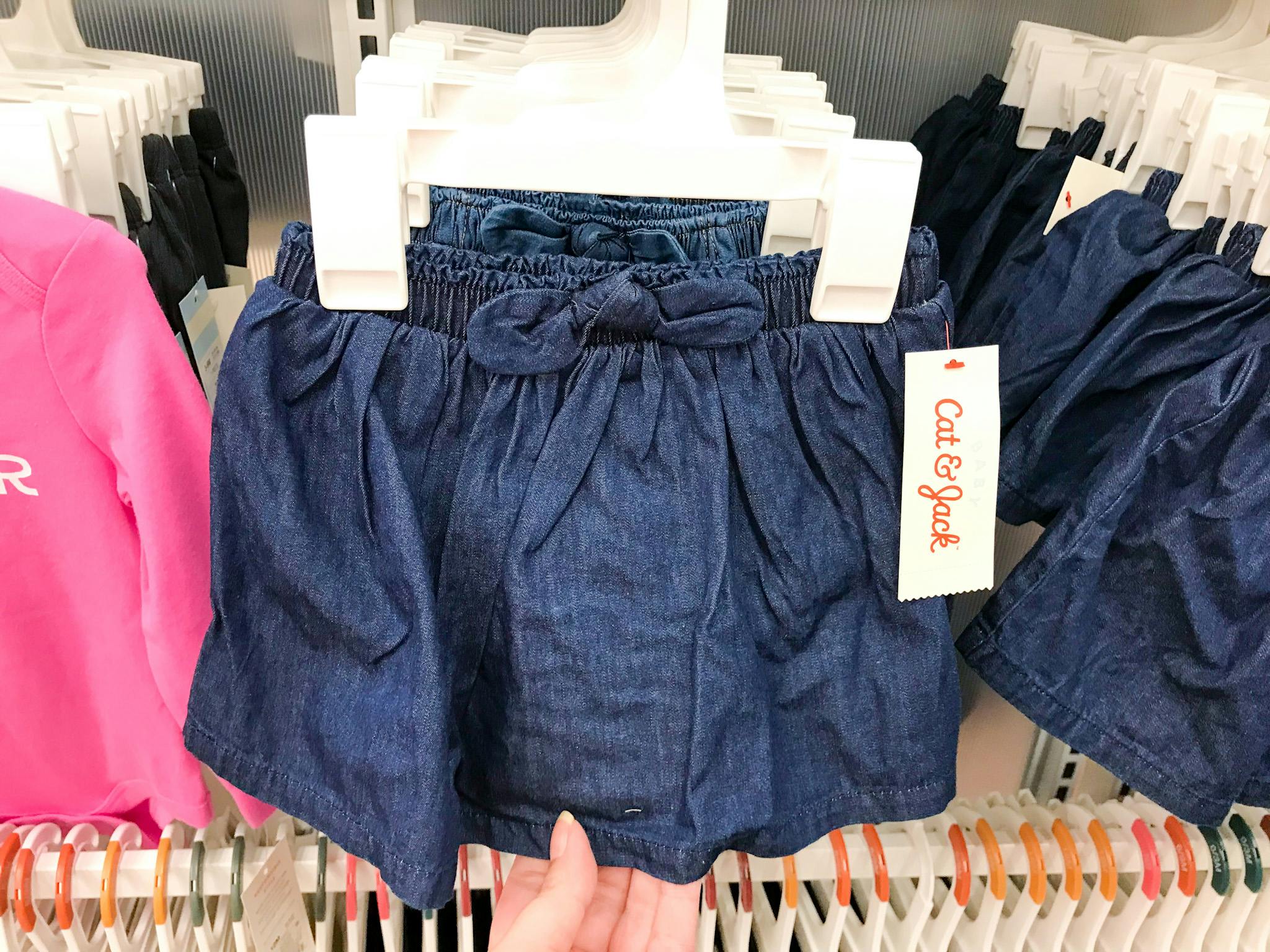 Cat & Jack denim skirts hanging in the kids clothing section at Target.