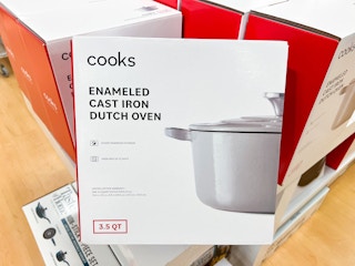 a white cast iron dutch oven in a box