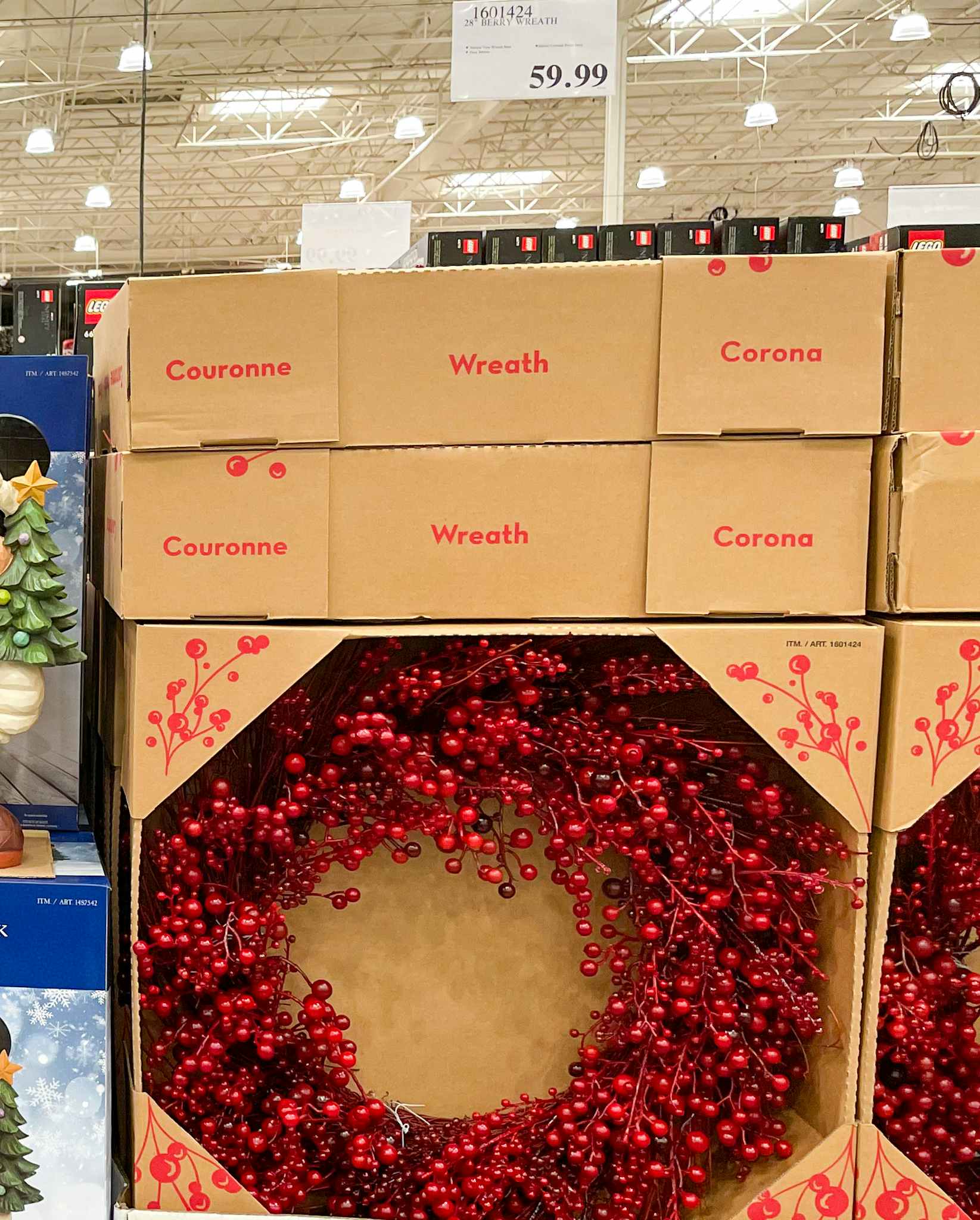 red berry wreath on display at costco with sale sign