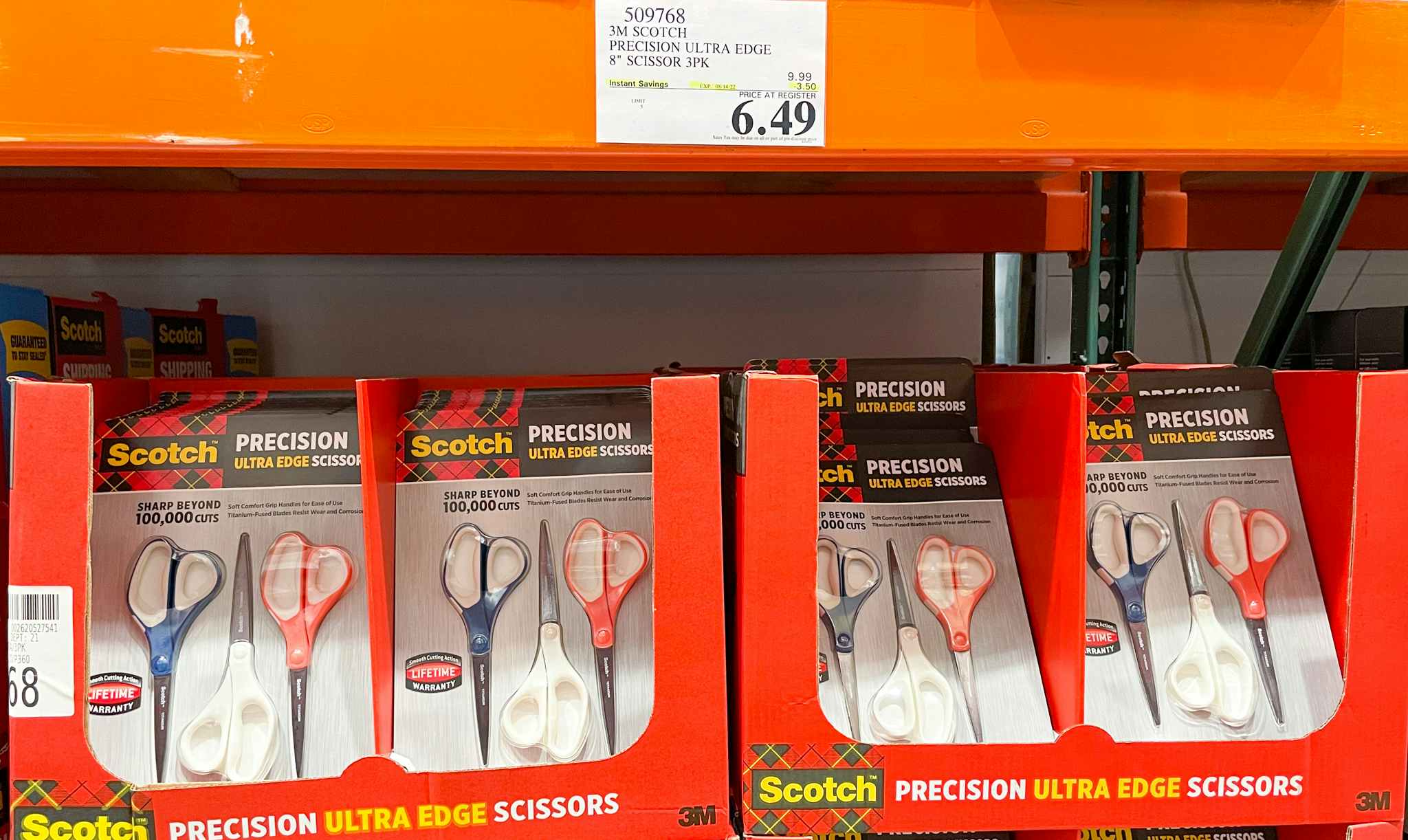 scissors on a shelf with sales sign at costco