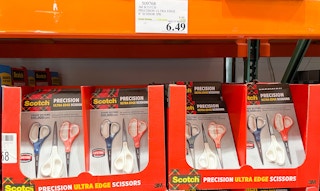 scissors on a shelf with sales sign at costco