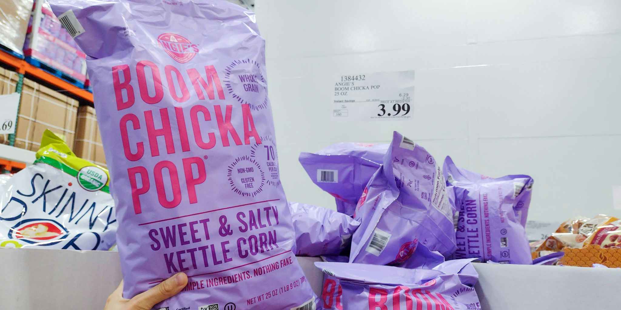 corn snack held in hand near sales sign at costco