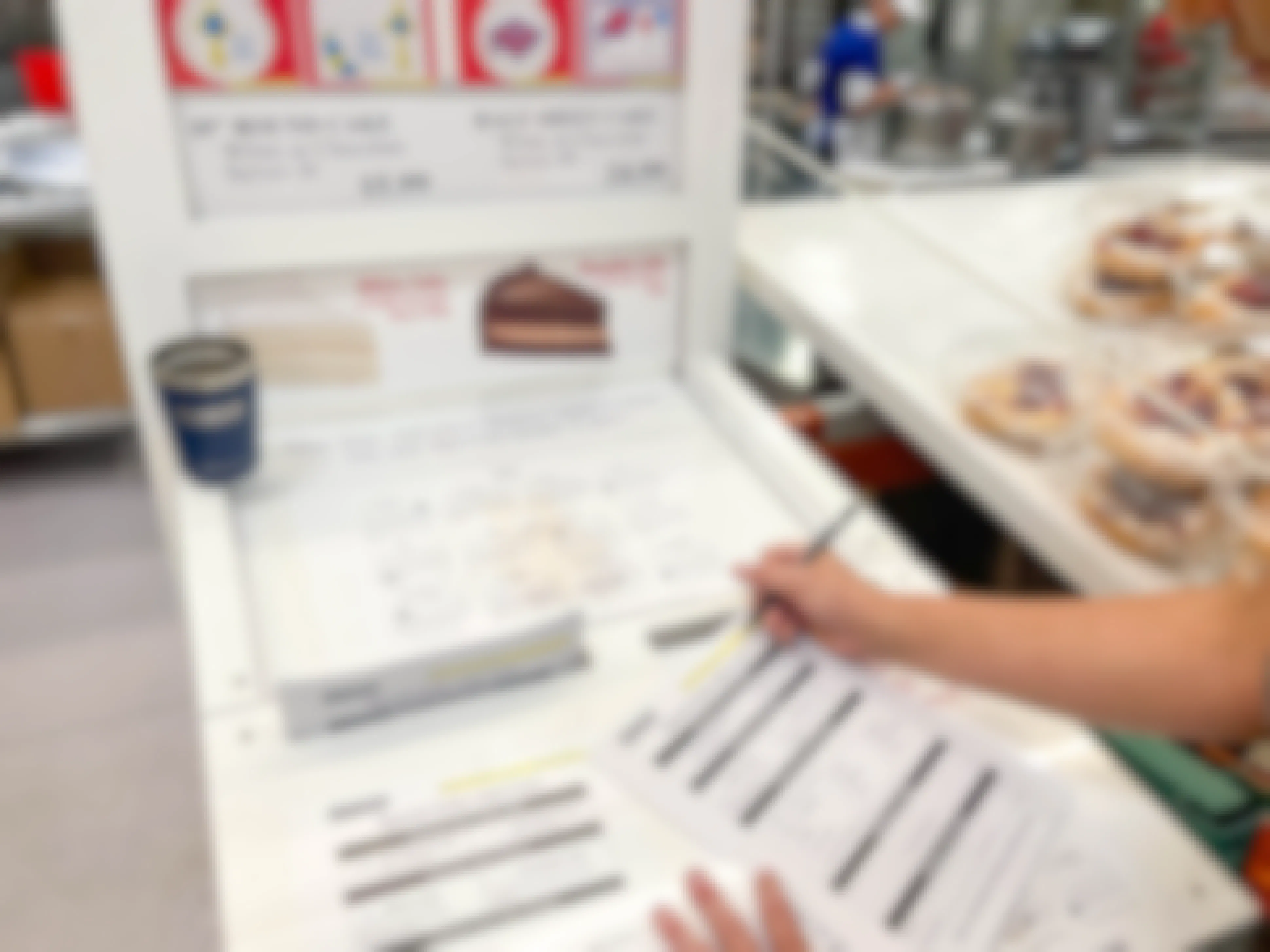 person filling out costco cake order sheet 