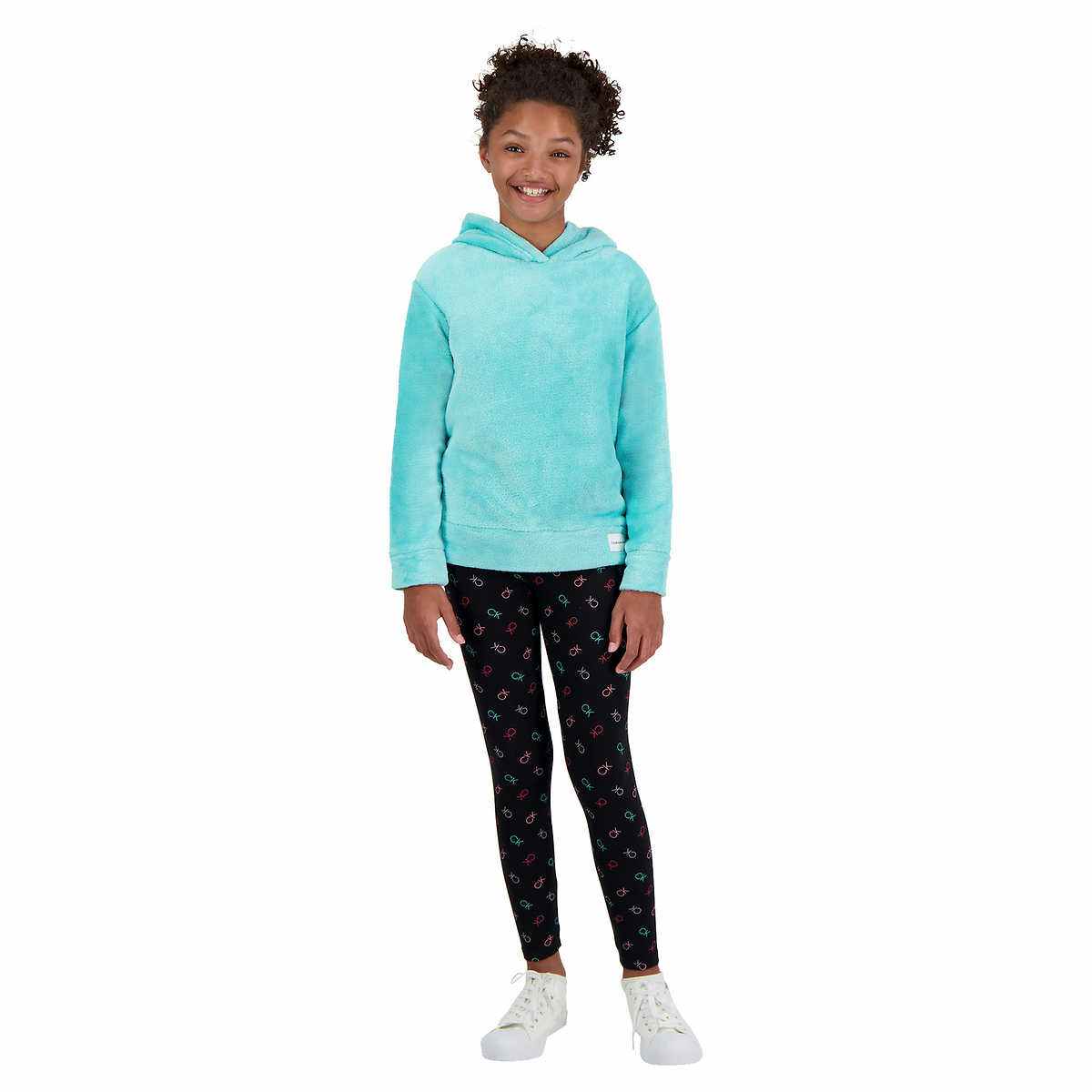child wearing a calvin klein youth set with black pants and a blue top