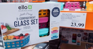 glass container set held in hand near sales sign at costco