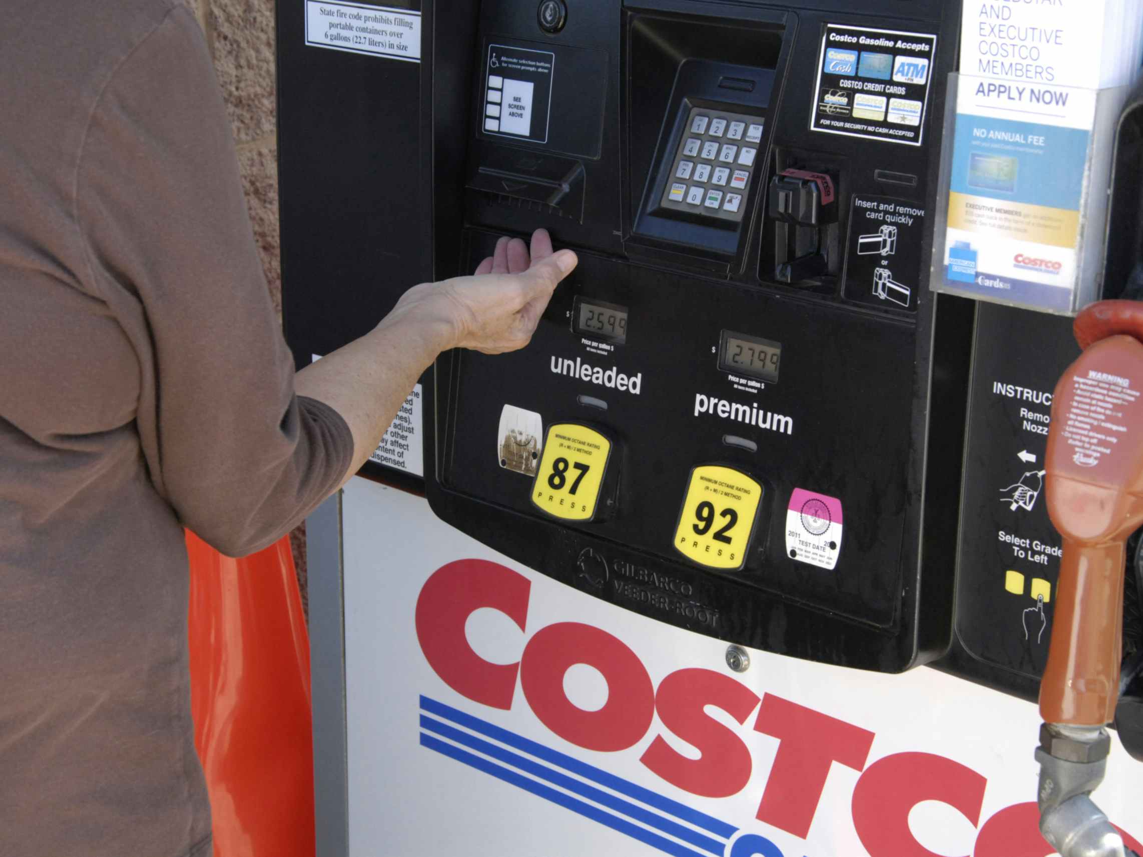 A person pumping gas at a Costco gas station.