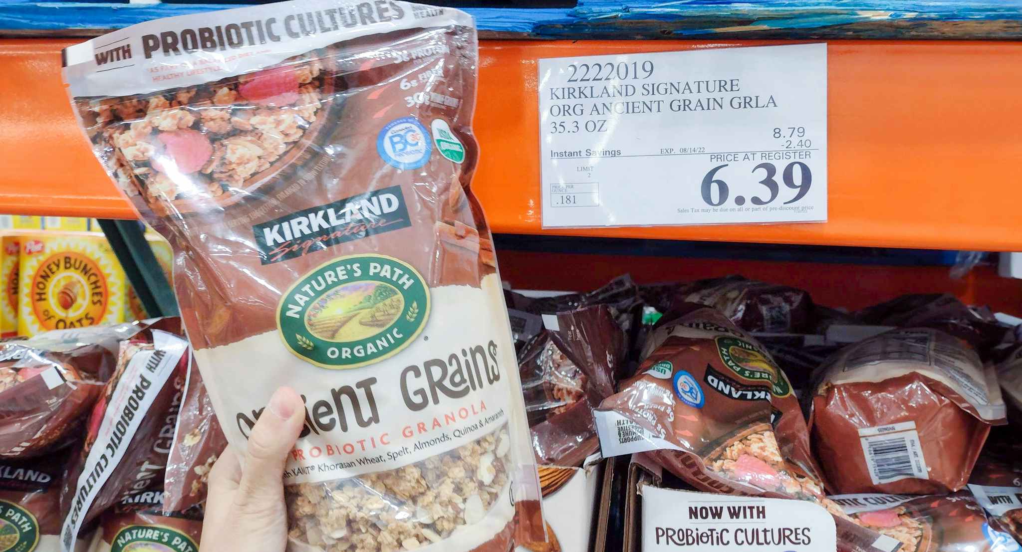 grains held in hand near sales sign