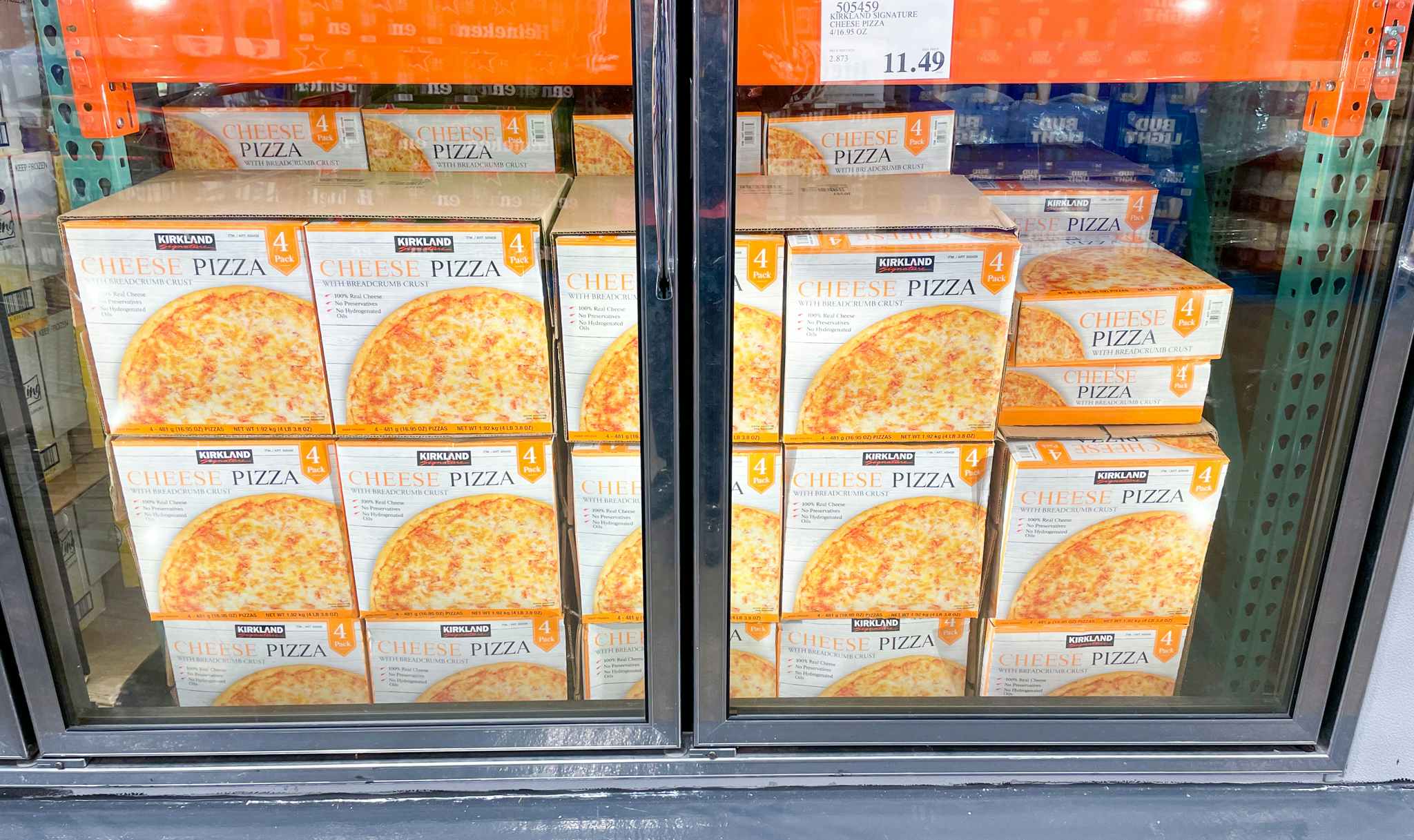 cheese pizza in a freezer with sale sign at costco
