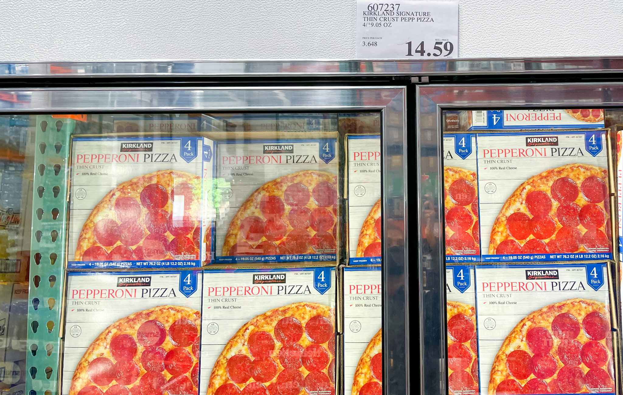 pepperoni pizzas in a freezer with sale sign at costco