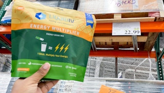 liquid i v held up near sale sign at costco