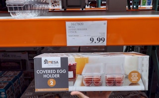 egg holder held in hand near sales sign