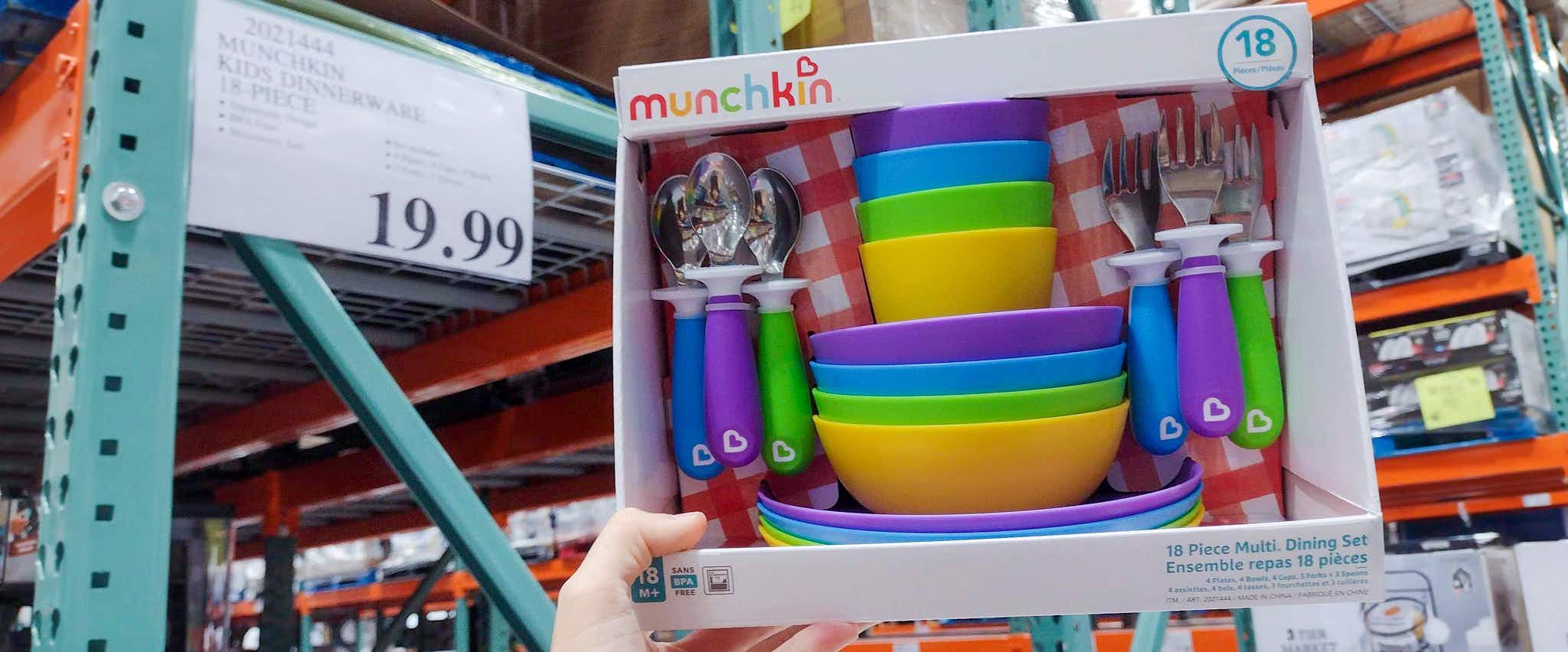 dinnerware set for toddlers held up near sale sign at costco