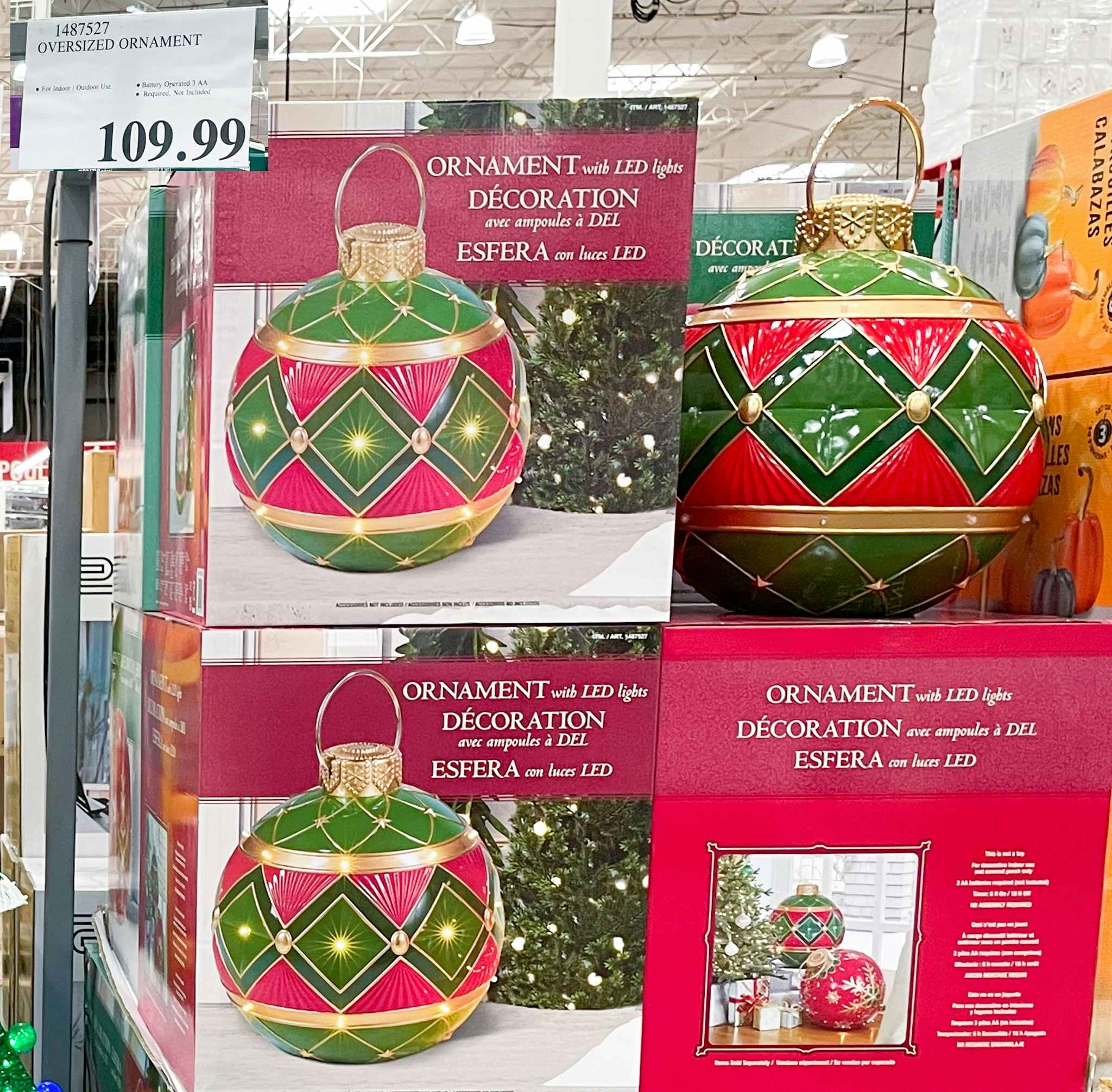 oversized christmas ornaments in a box with sale sign at costco