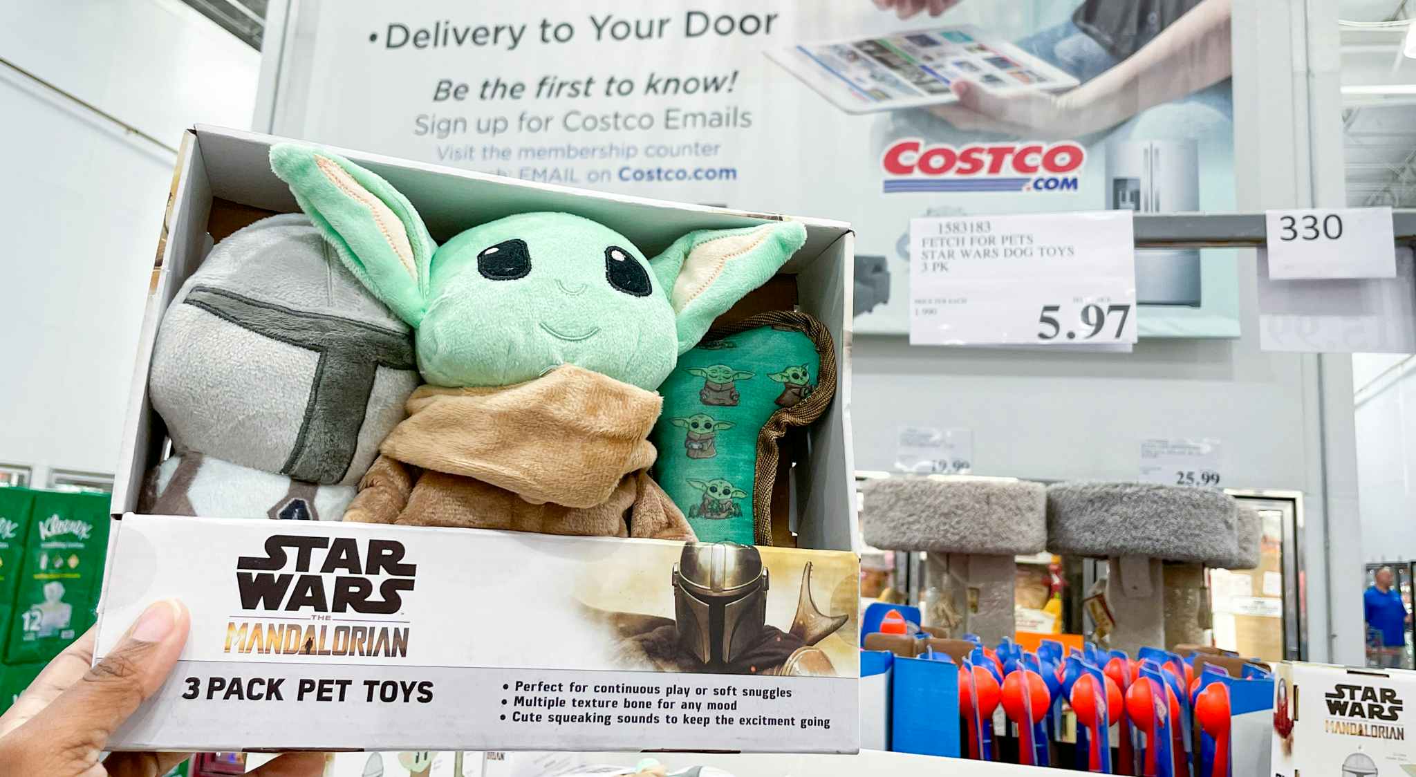 pet toy held up near sales sign at costco