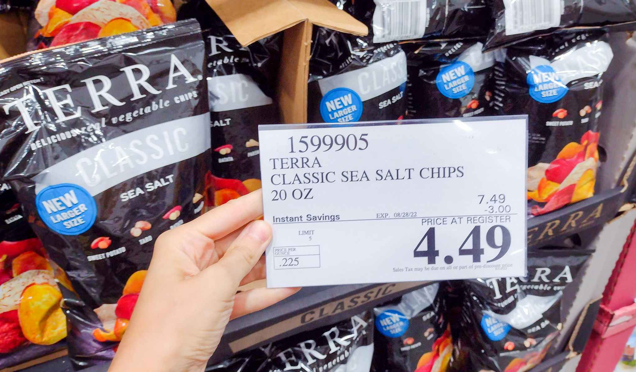 sales sign held in hand in front of chips 