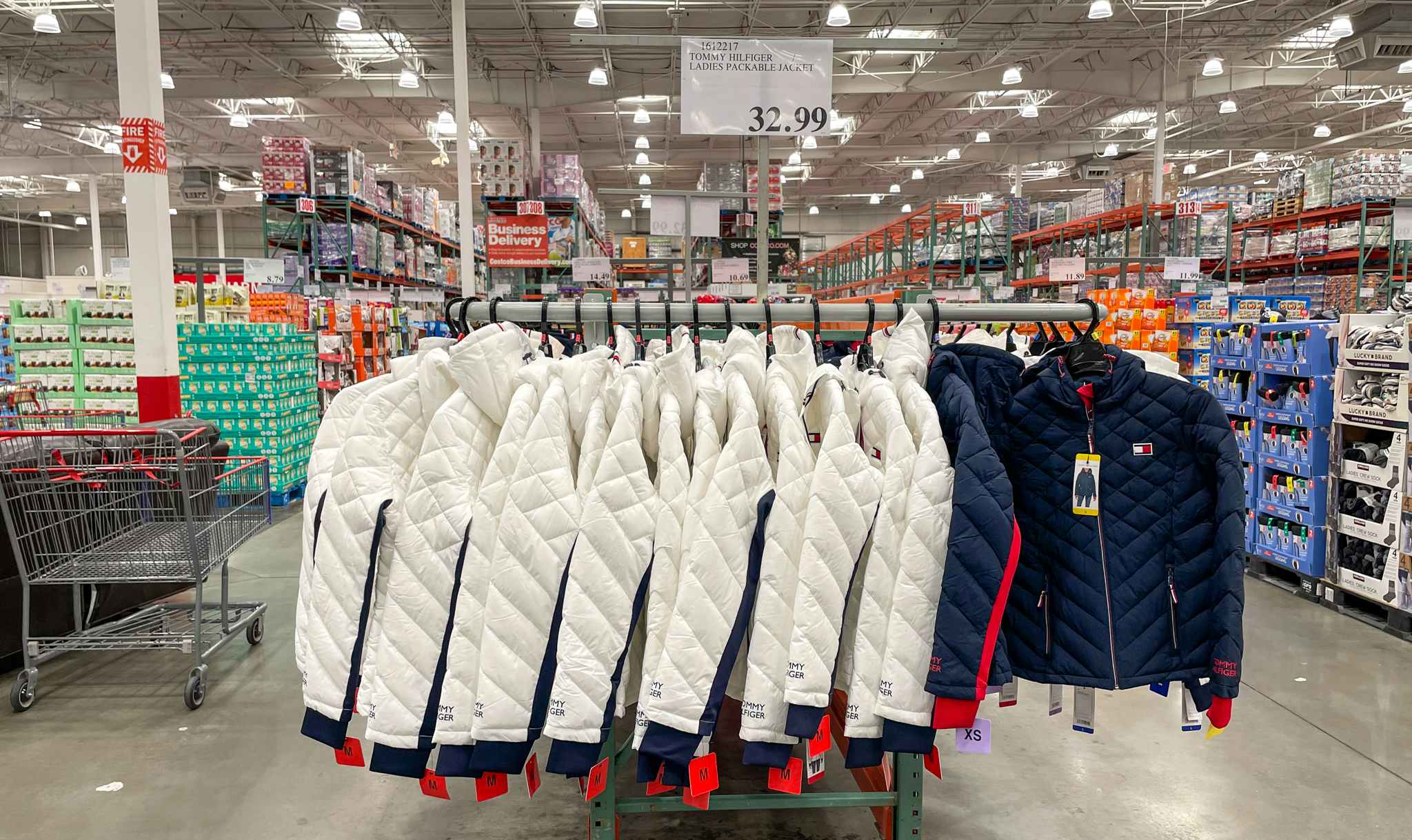 jackets on a rack with sale sign at costco