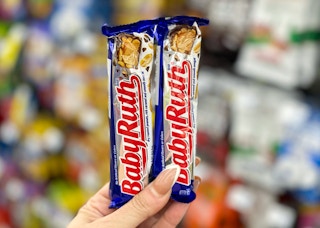 two baby ruth candy bars held in hand