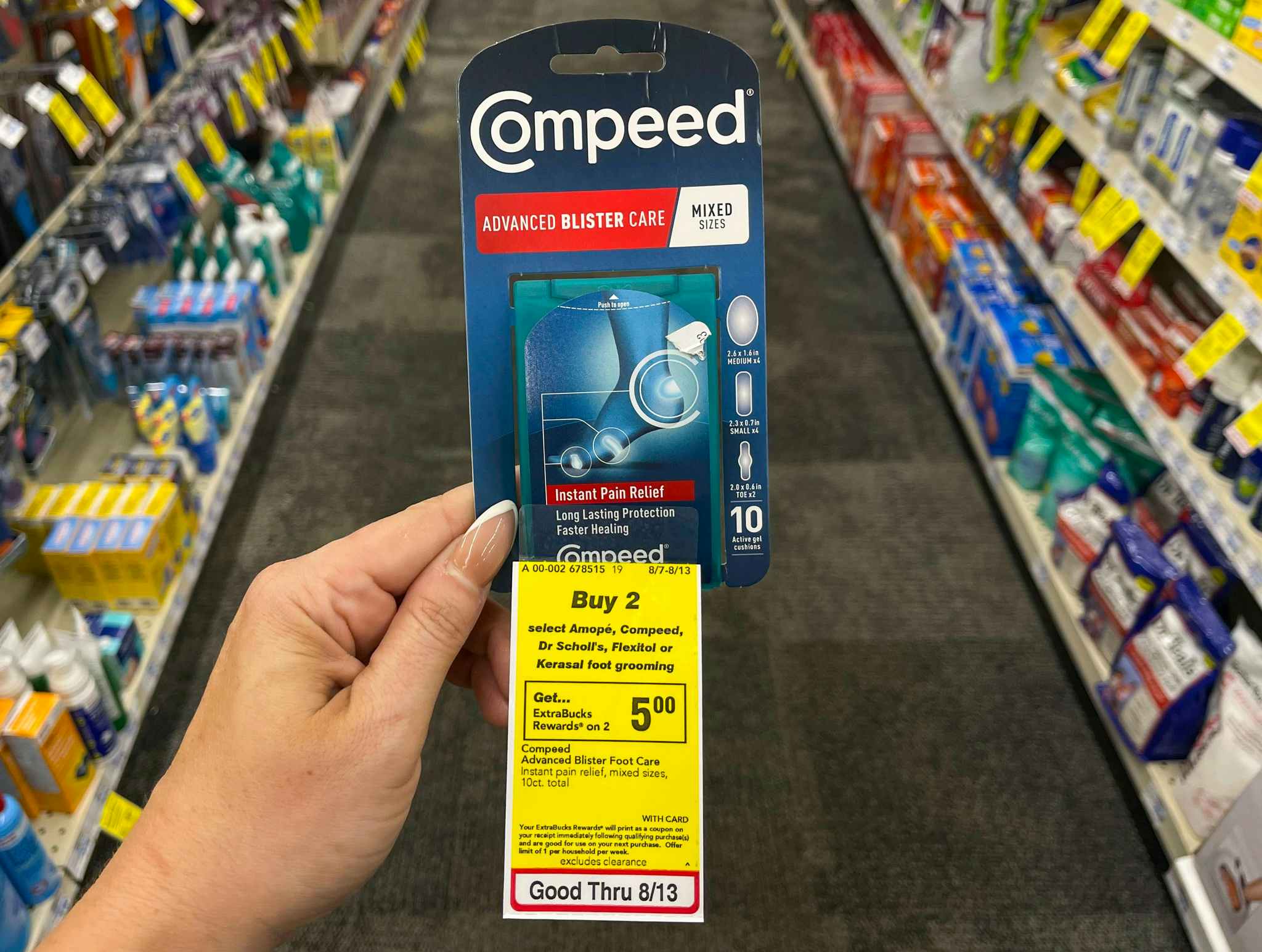 hand holding compeed package with extrabucks promotion tag