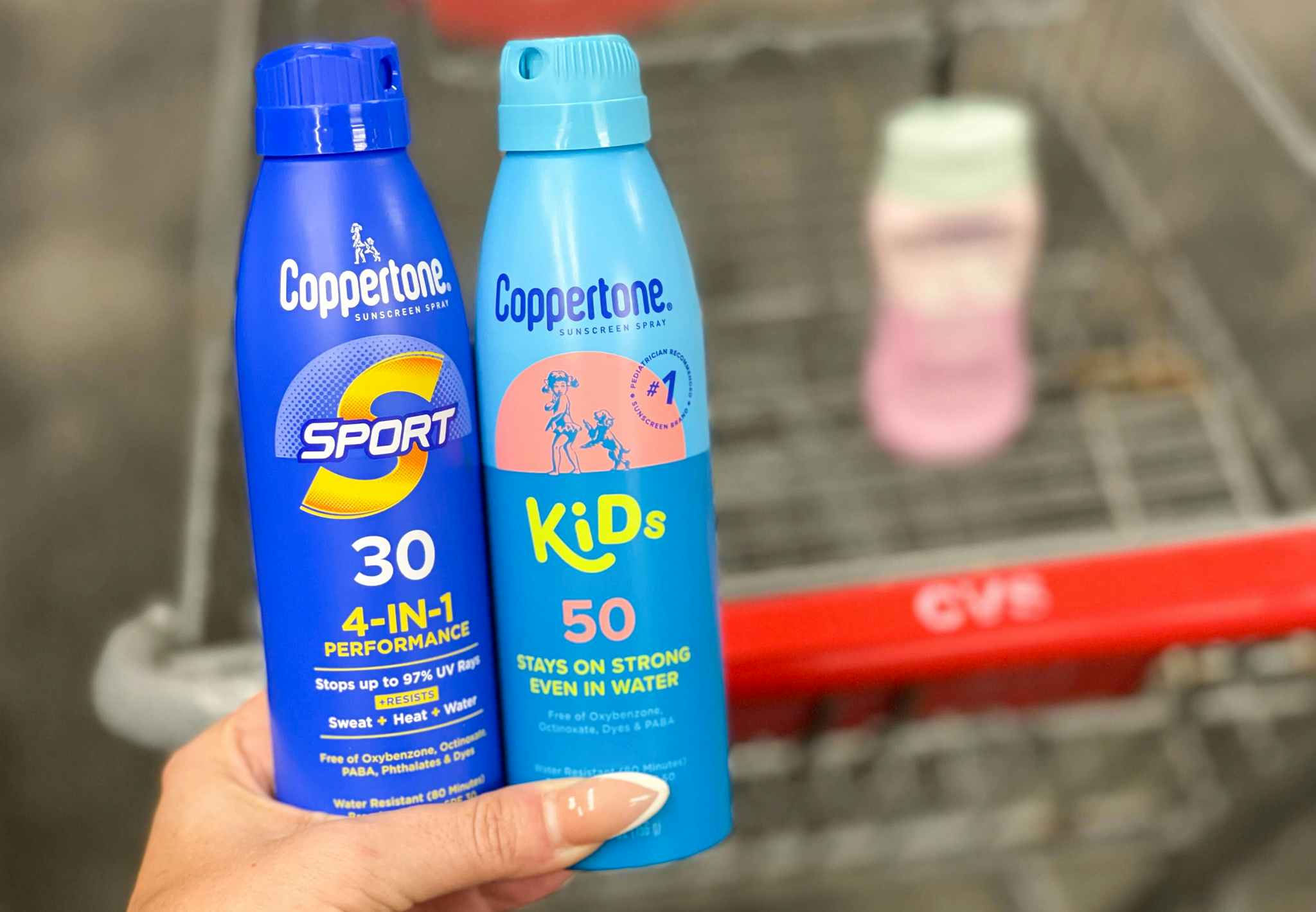 coppertone spray held in hand with coppertone in cart