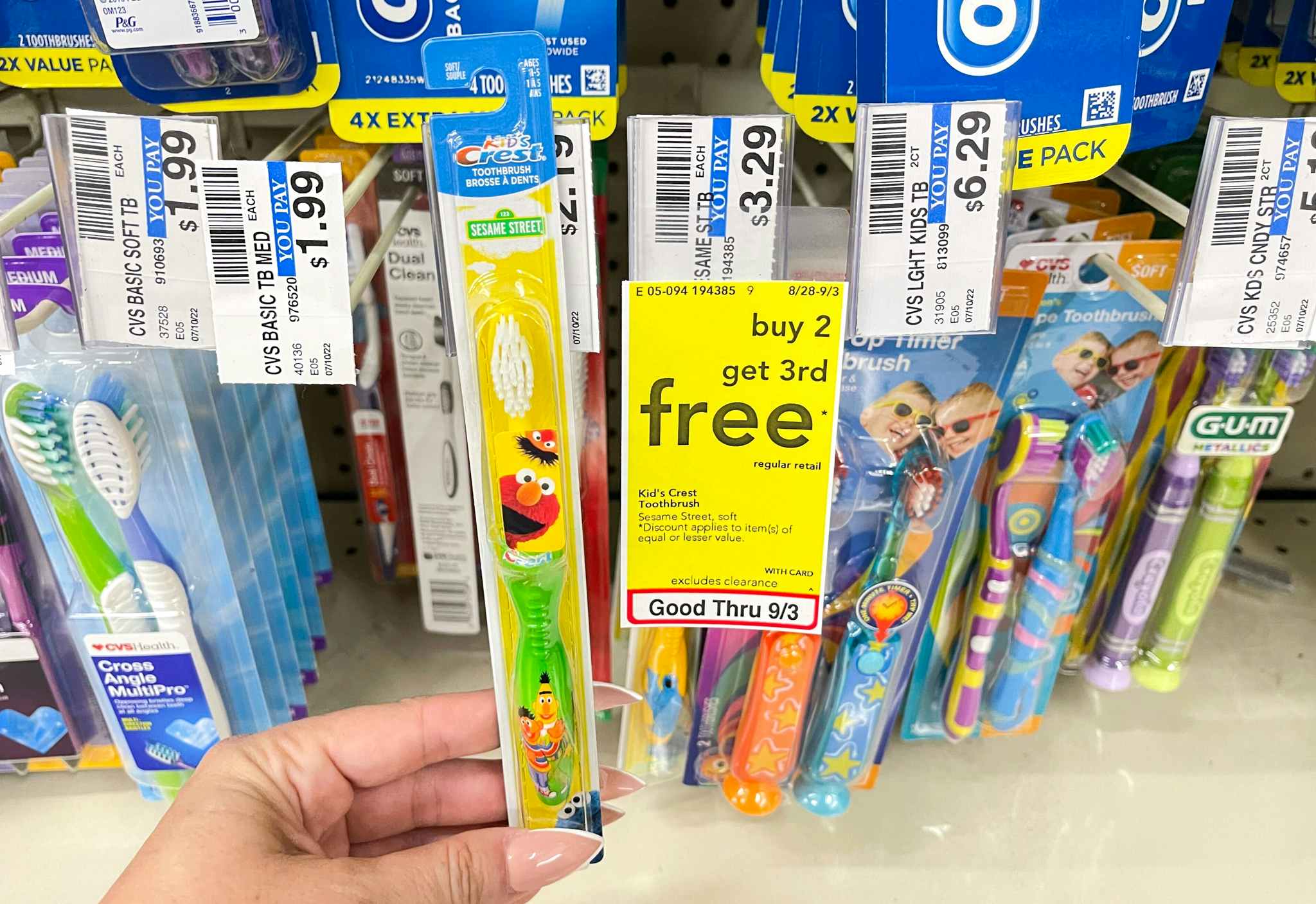 crest kid's toothbrush held next to sale tag