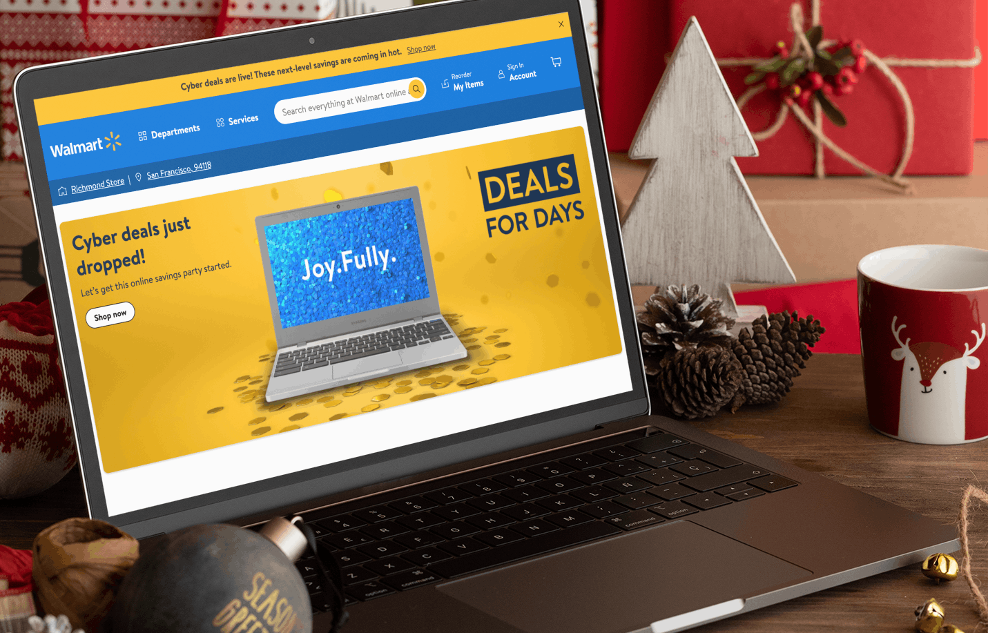 walmart cyber monday deals open on a laptop surrounded by christmas decorations