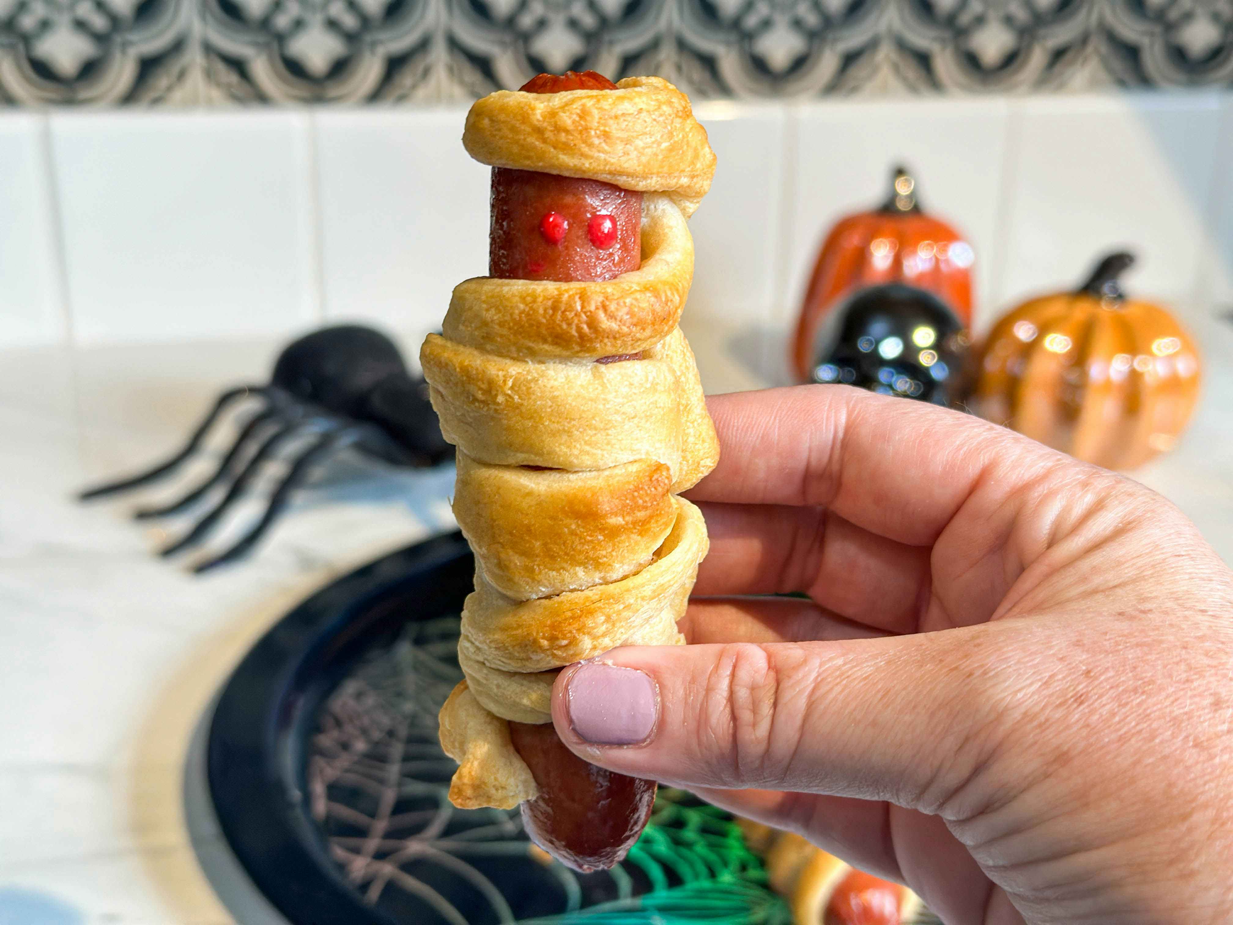 hot dog wrapped in crescent roll dough to look like a mummy 