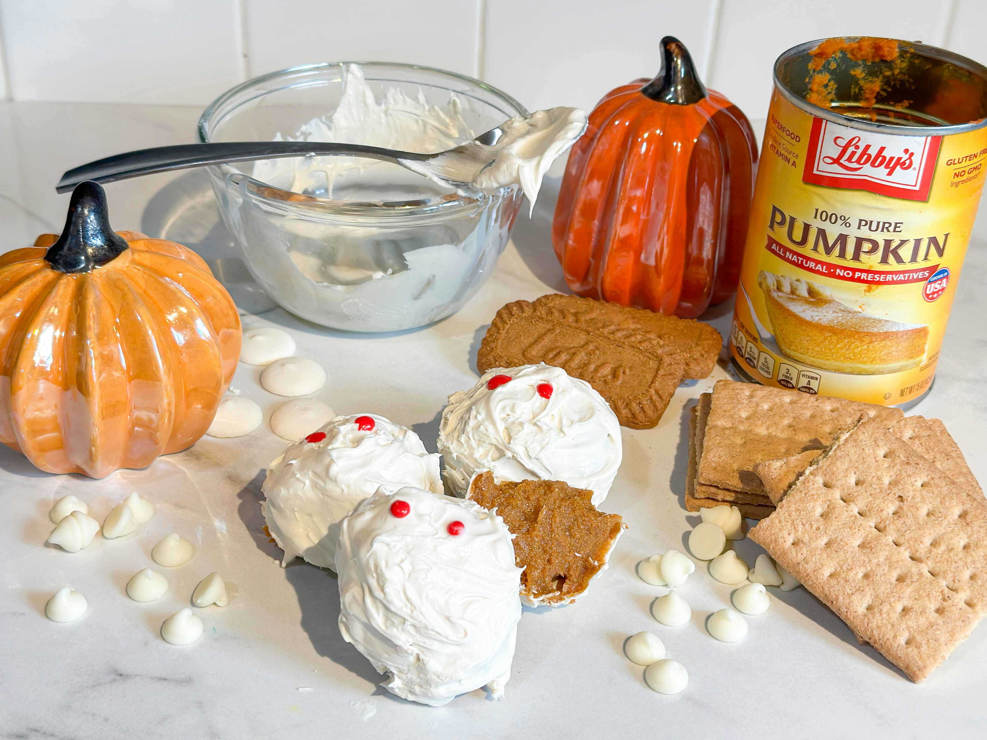 no bake mummy pumpkin truffles on counter with supplies 