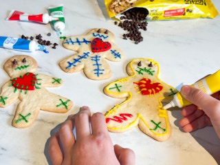 voodoo doll cookies being decorated on a countertop