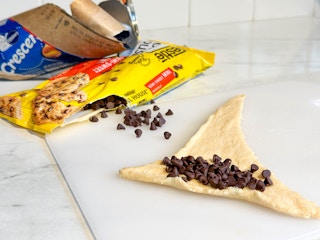 crescent roll dough layed out in the shape of a hat with chocolate chips on top