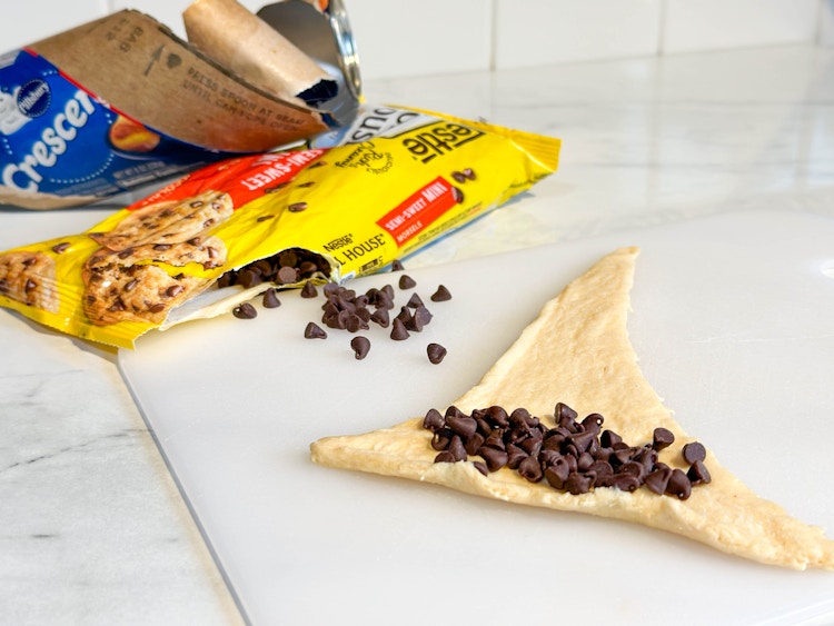 crescent roll dough layed out in the shape of a hat with chocolate chips on top 